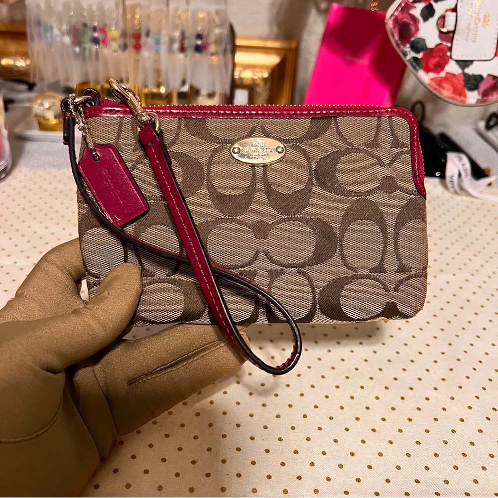 COACH small wristlet with signature monogram canvas.